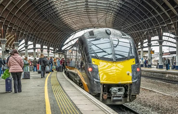 Yellow train stopping at train station